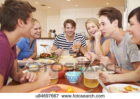 Group Of Young Friends Enjoying Meal At Home View Large Photo Image Stock Photo - Group Of Young Friends Enjoying Meal At Home. Fotosearch