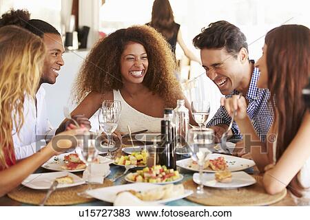 Group Of Young Friends Enjoying Meal In Outdoor Restaurant View Large Photo Image Stock Image - Group Of Young Friends Enjoying Meal In Outdoor Restaurant. Fotosearch