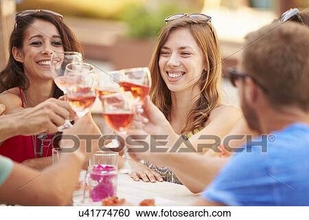 Group Of Young Friends Enjoying Meal In Outdoor Restaurant View Large Photo Image Stock Image - Group Of Young Friends Enjoying Meal In Outdoor Restaurant. Fotosearch