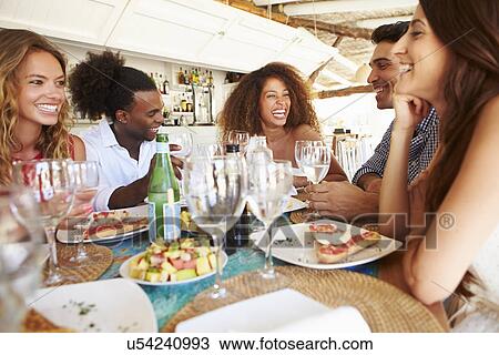 Group Of Young Friends Enjoying Meal In Outdoor Restaurant View Large Photo Image Stock Image - Group Of Young Friends Enjoying Meal In Outdoor Restaurant. Fotosearch