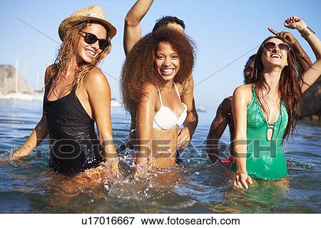 Stock Photo - Group Of Young Friends Having Fun In Sea Together. Fotosearch