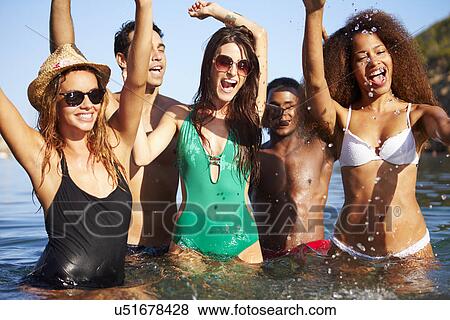 Stock Photo - Group Of Young Friends Having Fun In Sea Together. Fotosearch
