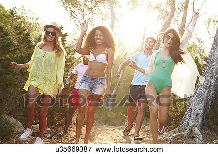 Stock Photo - Group Of Young Friends Having Party On Beach Together. Fotosearch