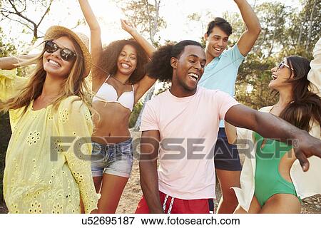 Group Of Young Friends Having Party On Beach Together View Large Photo Image Stock Photo - Group Of Young Friends Having Party On Beach Together. Fotosearch