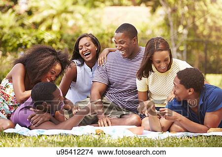 Group Of Young Friends Having Picnic Together View Large Photo Image Picture - Group Of Young Friends Having Picnic Together. Fotosearch