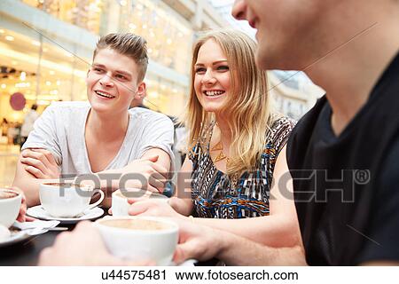 Group Of Young Friends Meeting In Cafe View Large Photo Image Stock Image - Group Of Young Friends Meeting In Cafe. Fotosearch