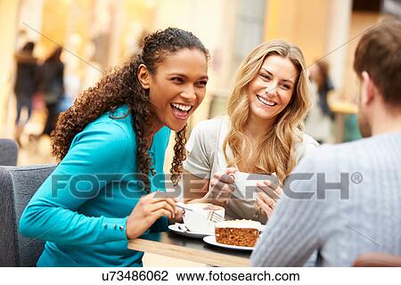 Group Of Young Friends Meeting In Cafe View Large Photo Image Stock Image - Group Of Young Friends Meeting In Cafe. Fotosearch