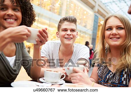 Group Of Young Friends Meeting In Cafe View Large Photo Image Stock Photo - Group Of Young Friends Meeting In Cafe. Fotosearch