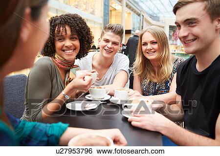 Group Of Young Friends Meeting In Cafe View Large Photo Image Stock Photograph - Group Of Young Friends Meeting In Cafe. Fotosearch