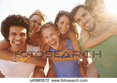 Stock Image - Group Of Young Friends On Summer Holiday Together . Fotosearch