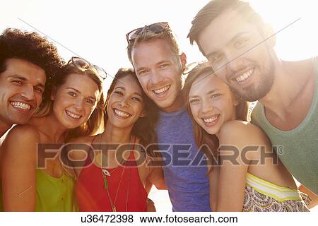 Stock Photo - Group Of Young Friends On Summer Holiday Together . Fotosearch