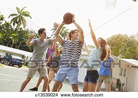 Picture - Group Of Young Friends Playing Basketball Match. Fotosearch