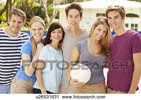 Stock Image - Group Of Young Friends Playing Volleyball Match. Fotosearch