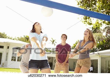 Group Of Young Friends Playing Volleyball Match View Large Photo Image Stock Image - Group Of Young Friends Playing Volleyball Match. Fotosearch