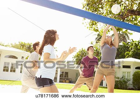 Group Of Young Friends Playing Volleyball Match View Large Photo Image Stock Photograph - Group Of Young Friends Playing Volleyball Match. Fotosearch