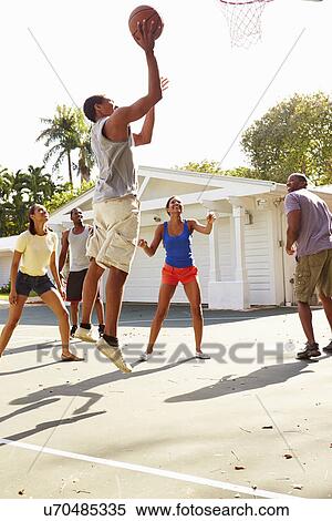 Stock Photography - Group Of Young Friends Playing Basketball Match. Fotosearch