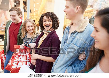 Picture - Group Of Young Friends Shopping In Mall Together. Fotosearch