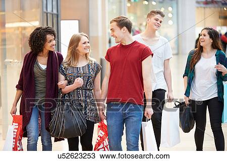 Group Of Young Friends Shopping In Mall Together View Large Photo Image Stock Image - Group Of Young Friends Shopping In Mall Together. Fotosearch