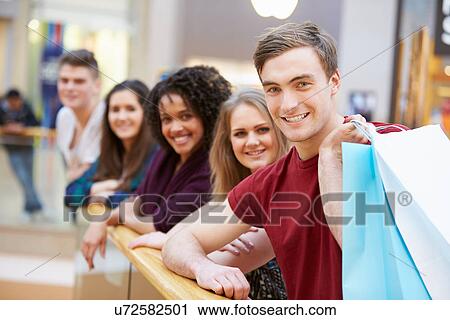 Group Of Young Friends Shopping In Mall Together View Large Photo Image Stock Image - Group Of Young Friends Shopping In Mall Together. Fotosearch