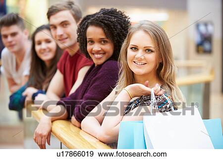 Stock Photo - Group Of Young Friends Shopping In Mall Together. Fotosearch