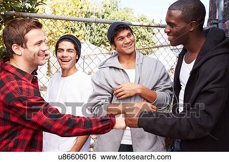 Group Of Young Men Greeting One Another In Urban Setting View Large Photo Image Stock Photograph - Group Of Young Men Greeting One Another In Urban Setting . Fotosearch
