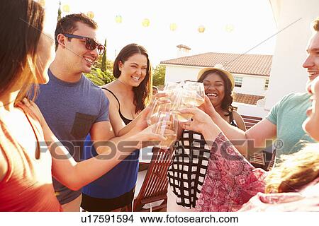 Group Of Young People Enjoying Outdoor Summer Meal View Large Photo Image Picture - Group Of Young People Enjoying Outdoor Summer Meal. Fotosearch