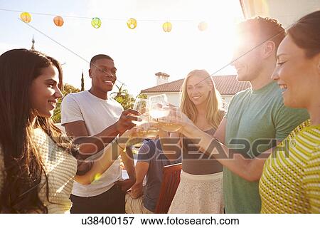 Group Of Young People Enjoying Outdoor Summer Meal View Large Photo Image Stock Photo - Group Of Young People Enjoying Outdoor Summer Meal. Fotosearch