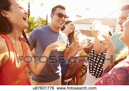 Group Of Young People Enjoying Outdoor Summer Meal View Large Photo Image Stock Photograph - Group Of Young People Enjoying Outdoor Summer Meal. Fotosearch