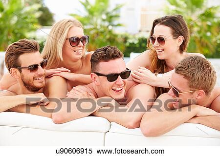 Group Of Young People On Holiday Relaxing By Swimming Pool View Large Photo Image Stock Photography - Group Of Young People On Holiday Relaxing By Swimming Pool. Fotosearch