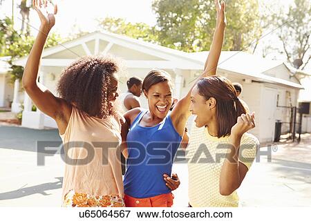 Stock Photo - Group Of Young Women Cheering At Basketball Match. Fotosearch