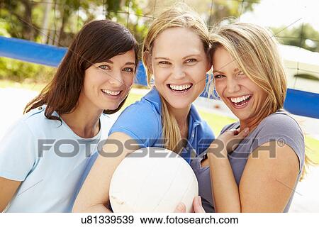 Stock Photo - Group Of Young Women Playing Volleyball Match. Fotosearch