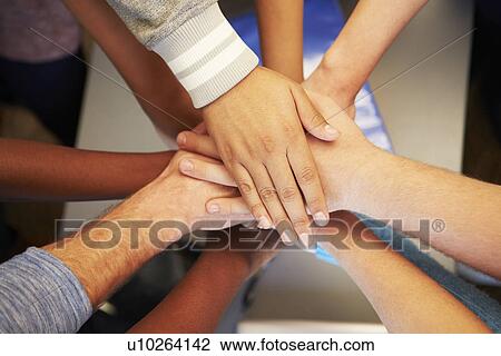 Stock Image - Hands From Young People Of Different Races Joined Together. Fotosearch