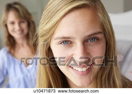 Stock Image - Happy teenage girl with mother. Fotosearch