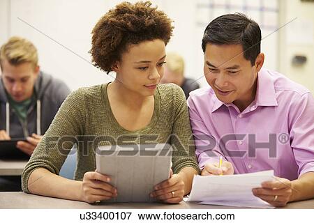 High School Student And Teacher Using Digital Tablet View Large Photo Image Stock Photo - High School Student And Teacher Using Digital Tablet. Fotosearch