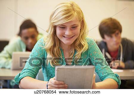 High School Student At Desk In Class Using Digital Tablet View Large Photo Image Picture - High School Student At Desk In Class Using Digital Tablet. Fotosearch