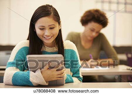 High School Student At Desk In Class Using Digital Tablet View Large Photo Image Stock Photo - High School Student At Desk In Class Using Digital Tablet. Fotosearch