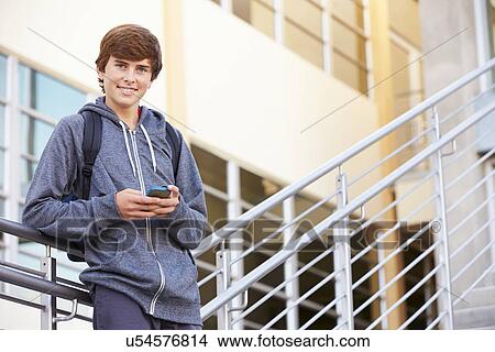 High School Student Standing Outside Building With Phone View Large Photo Image Picture - High School Student Standing Outside Building With Phone. Fotosearch