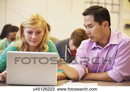 High School Student With Teacher In Class Using Laptop View Large Photo Image Stock Image - High School Student With Teacher In Class Using Laptop. Fotosearch