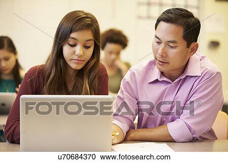 High School Student With Teacher In Class Using Laptop View Large Photo Image Stock Image - High School Student With Teacher In Class Using Laptop. Fotosearch
