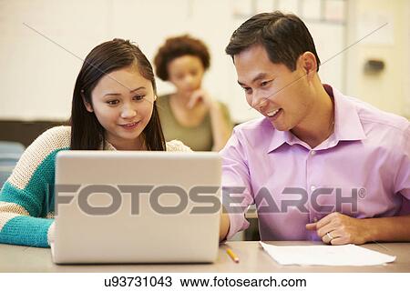 High School Student With Teacher In Class Using Laptop View Large Photo Image Stock Image - High School Student With Teacher In Class Using Laptop. Fotosearch