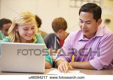 High School Student With Teacher In Class Using Laptop View Large Photo Image Stock Photo - High School Student With Teacher In Class Using Laptop. Fotosearch