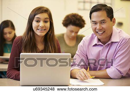 High School Student With Teacher In Class Using Laptop View Large Photo Image Stock Photo - High School Student With Teacher In Class Using Laptop. Fotosearch
