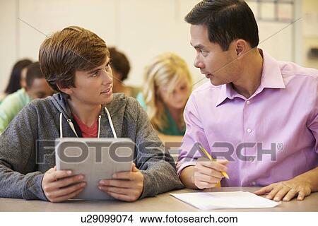 Picture - High School Student With Teacher Using Digital Tablet. Fotosearch