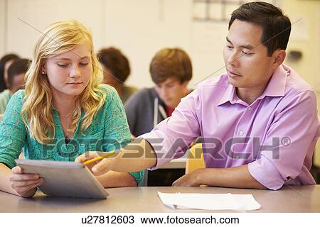 High School Student With Teacher Using Digital Tablet View Large Photo Image Stock Image - High School Student With Teacher Using Digital Tablet. Fotosearch
