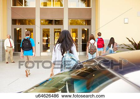 Stock Photograph - High School Students Being Dropped Off At School By Parents. Fotosearch