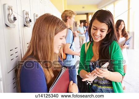High School Students By Lockers Looking At Mobile Phone View Large Photo Image Stock Image - High School Students By Lockers Looking At Mobile Phone. Fotosearch