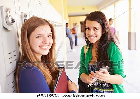 High School Students By Lockers Looking At Mobile Phone View Large Photo Image Stock Photo - High School Students By Lockers Looking At Mobile Phone. Fotosearch