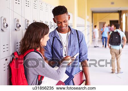 High School Students By Lockers Looking At Mobile Phone View Large Photo Image Stock Photography - High School Students By Lockers Looking At Mobile Phone. Fotosearch