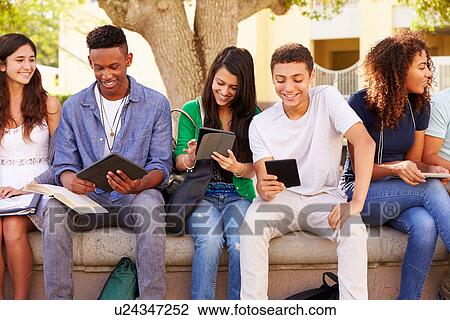 Stock Image - High School Students Collaborating On Project On Campus. Fotosearch