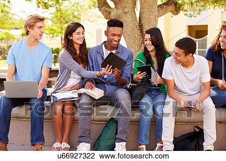 Stock Image - High School Students Collaborating On Project On Campus. Fotosearch